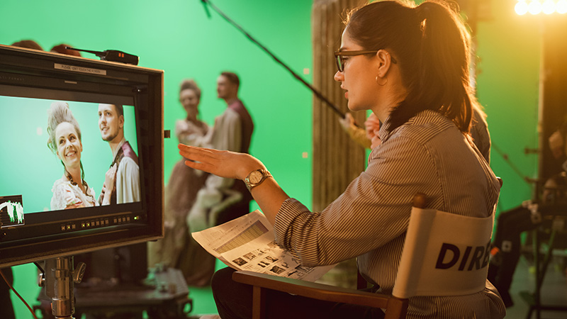 woman directing shoot in front of green screen